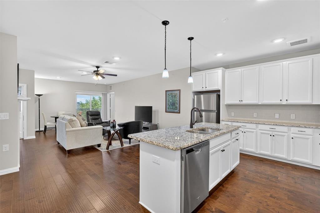 651 Watters Road, Unit 5305 Allen, TX 75013 - Photo 9 of 40 a open kitchen with kitchen island white cabinets and refrigerator