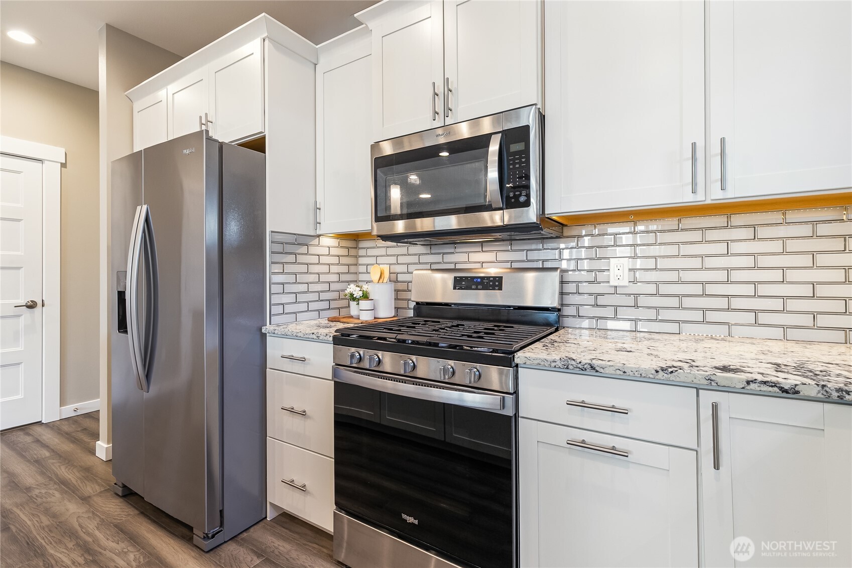 5686 Sunstone Place, Unit 101 Ferndale, WA 98248 - Photo 11 of 32 a kitchen with stainless steel appliances and cabinets