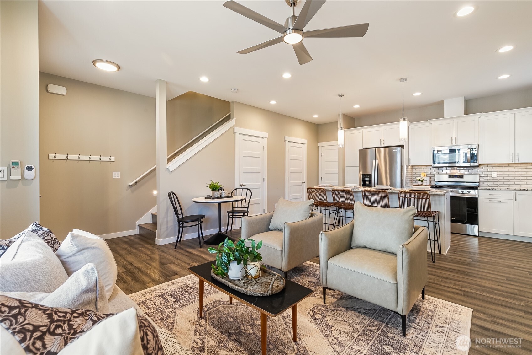 5686 Sunstone Place, Unit 101 Ferndale, WA 98248 - Photo 12 of 32 a living room with furniture kitchen and a chandelier