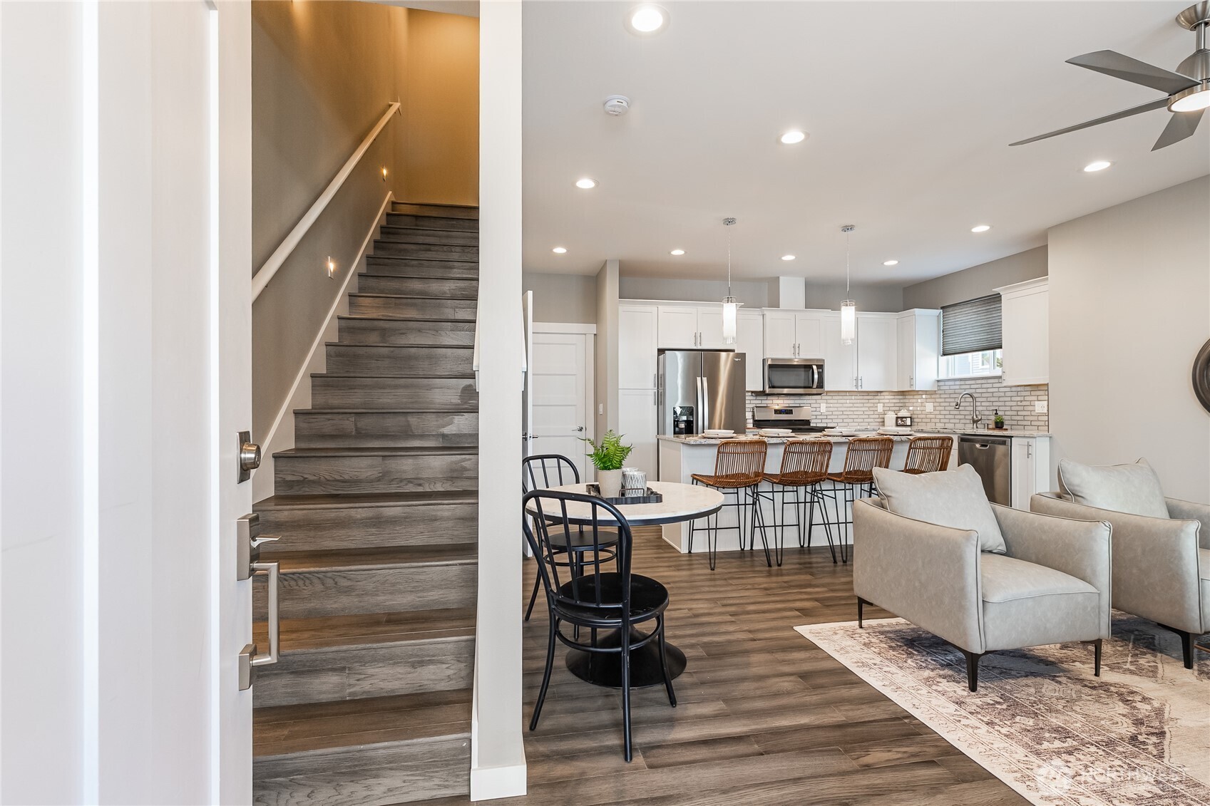 5686 Sunstone Place, Unit 101 Ferndale, WA 98248 - Photo 13 of 32 a living room with furniture and a dining table with wooden floor