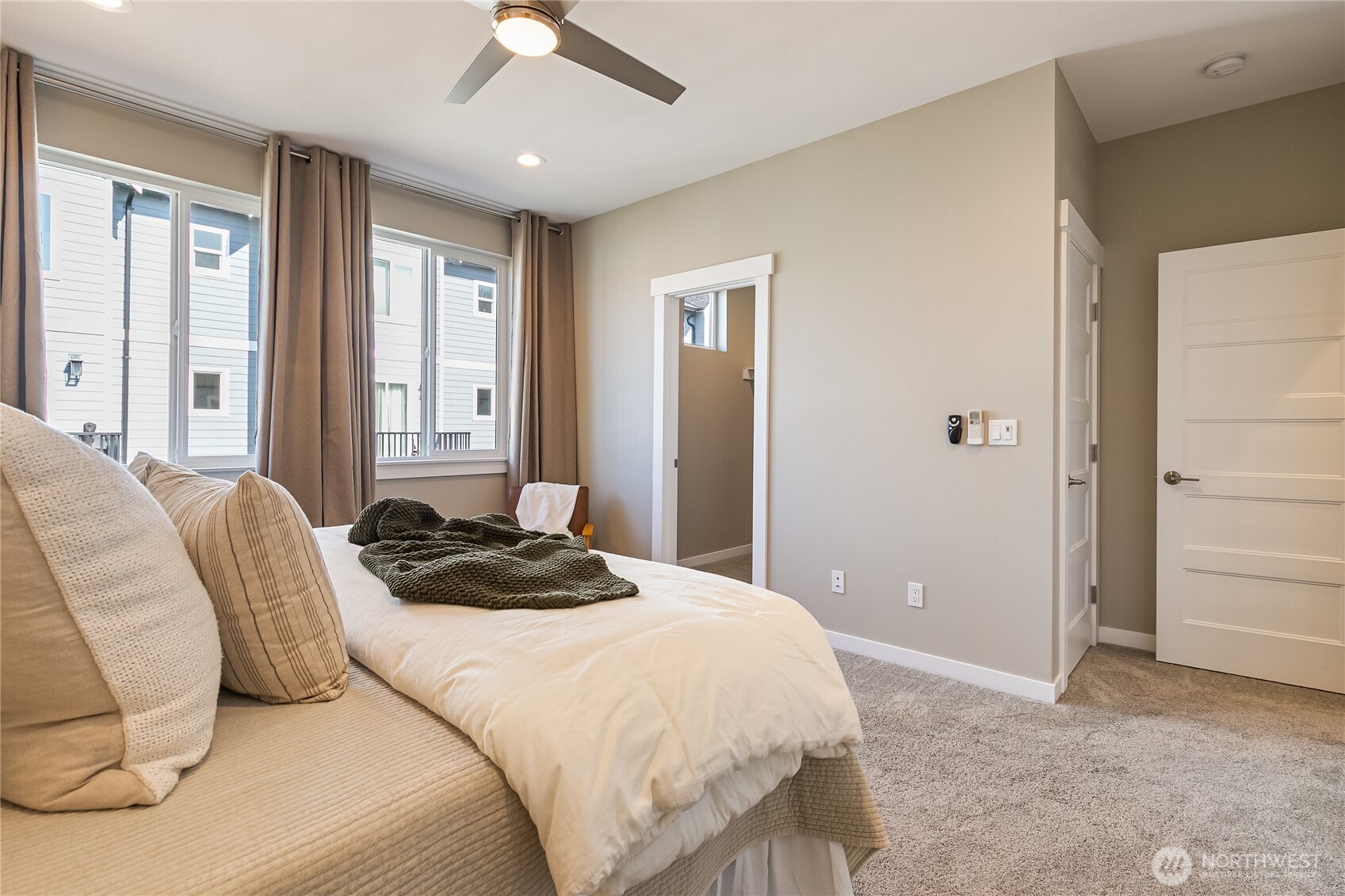 5686 Sunstone Place, Unit 101 Ferndale, WA 98248 - Photo 15 of 32 a bedroom with a bed and a chandelier