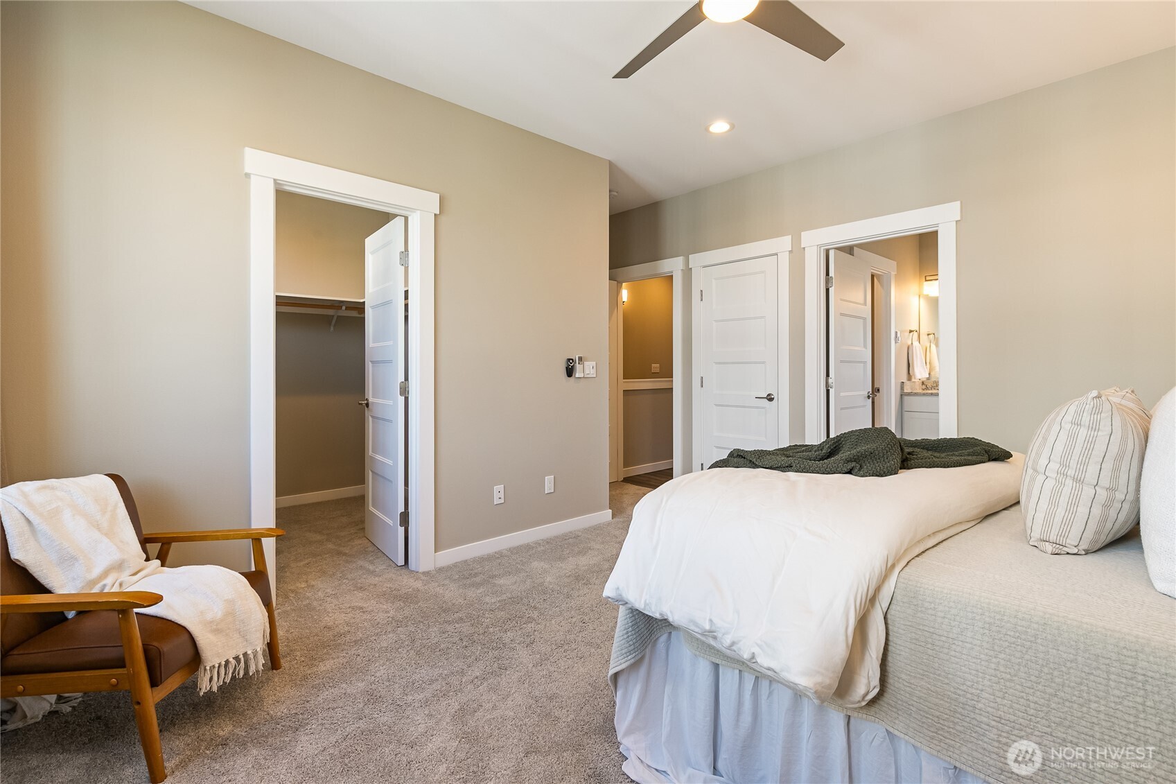 5686 Sunstone Place, Unit 101 Ferndale, WA 98248 - Photo 16 of 32 a bedroom with a bed and a chandelier