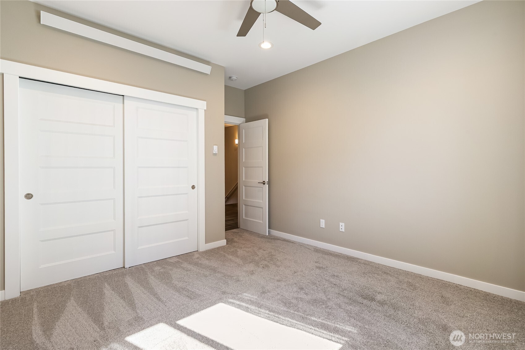 5686 Sunstone Place, Unit 101 Ferndale, WA 98248 - Photo 22 of 32 an empty room with closet and fan