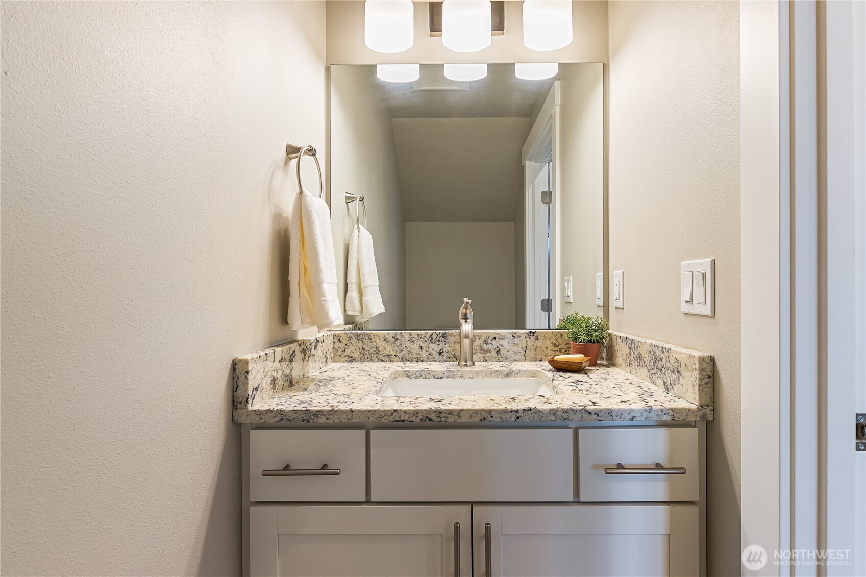 5686 Sunstone Place, Unit 101 Ferndale, WA 98248 - Photo 27 of 32 a bathroom with a granite countertop sink and a mirror