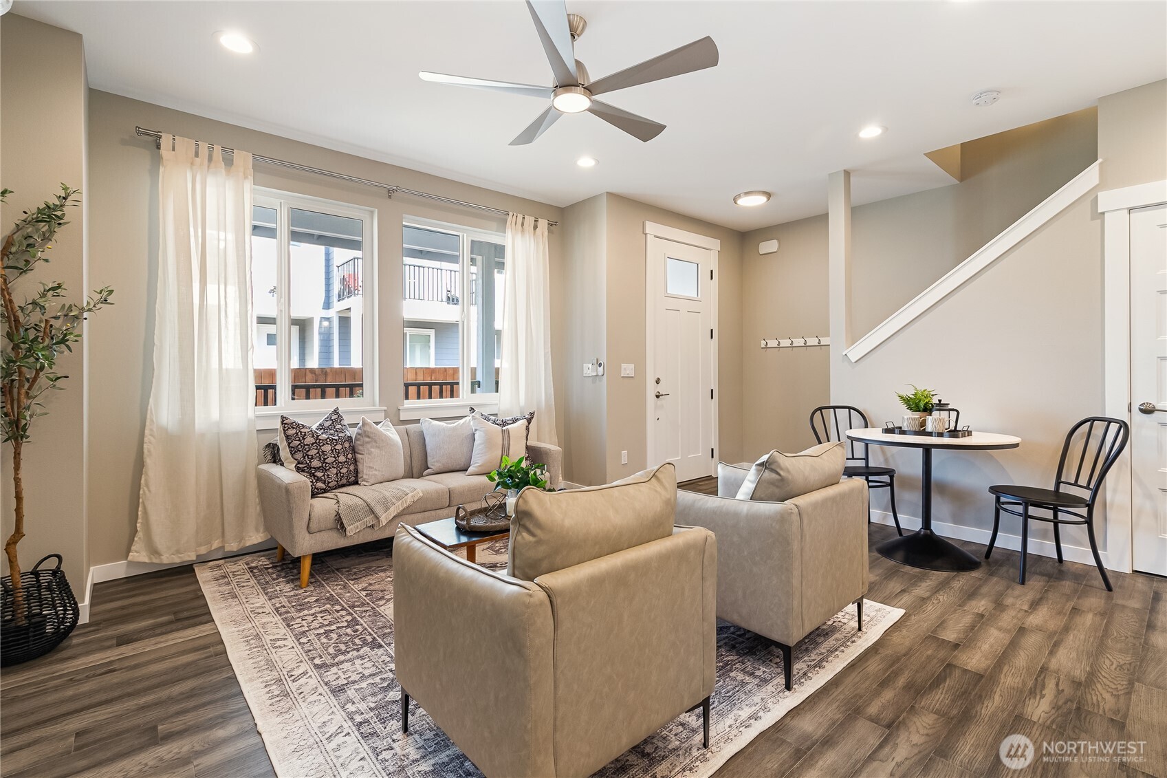 5686 Sunstone Place, Unit 101 Ferndale, WA 98248 - Photo 6 of 32 a living room with furniture and wooden floor