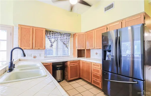 a kitchen with stainless steel appliances granite countertop a refrigerator and a sink