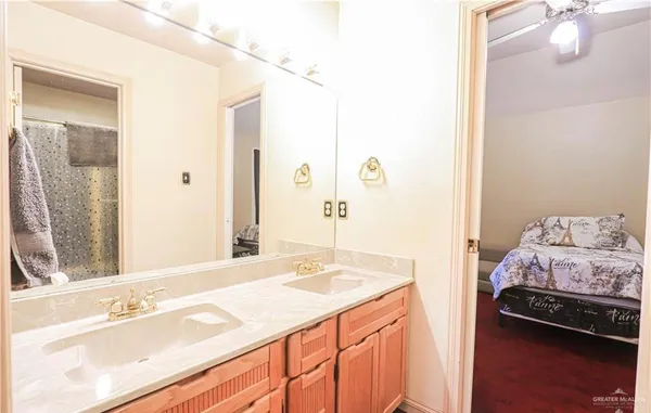 a bathroom with a sink double vanity and a mirror
