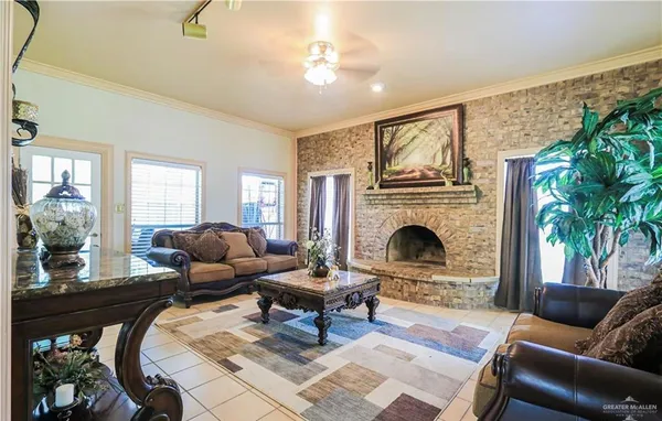 a living room with furniture a fireplace and a floor to ceiling window