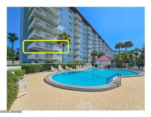 a view of swimming pool with outdoor seating