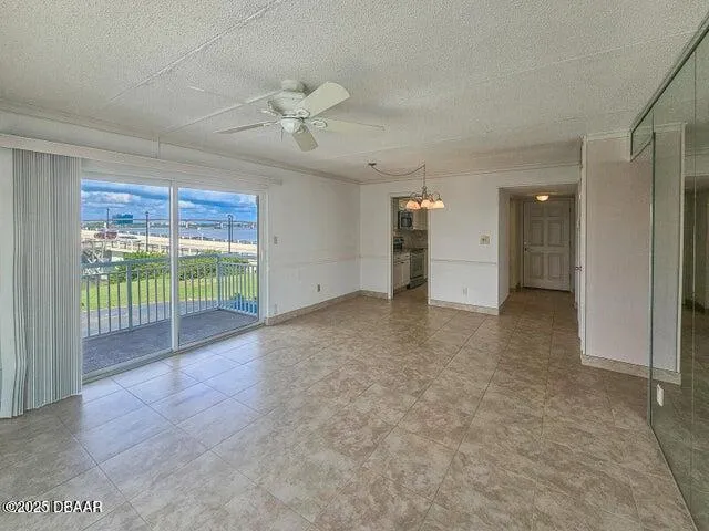 a view of a livingroom with a ceiling fan and window