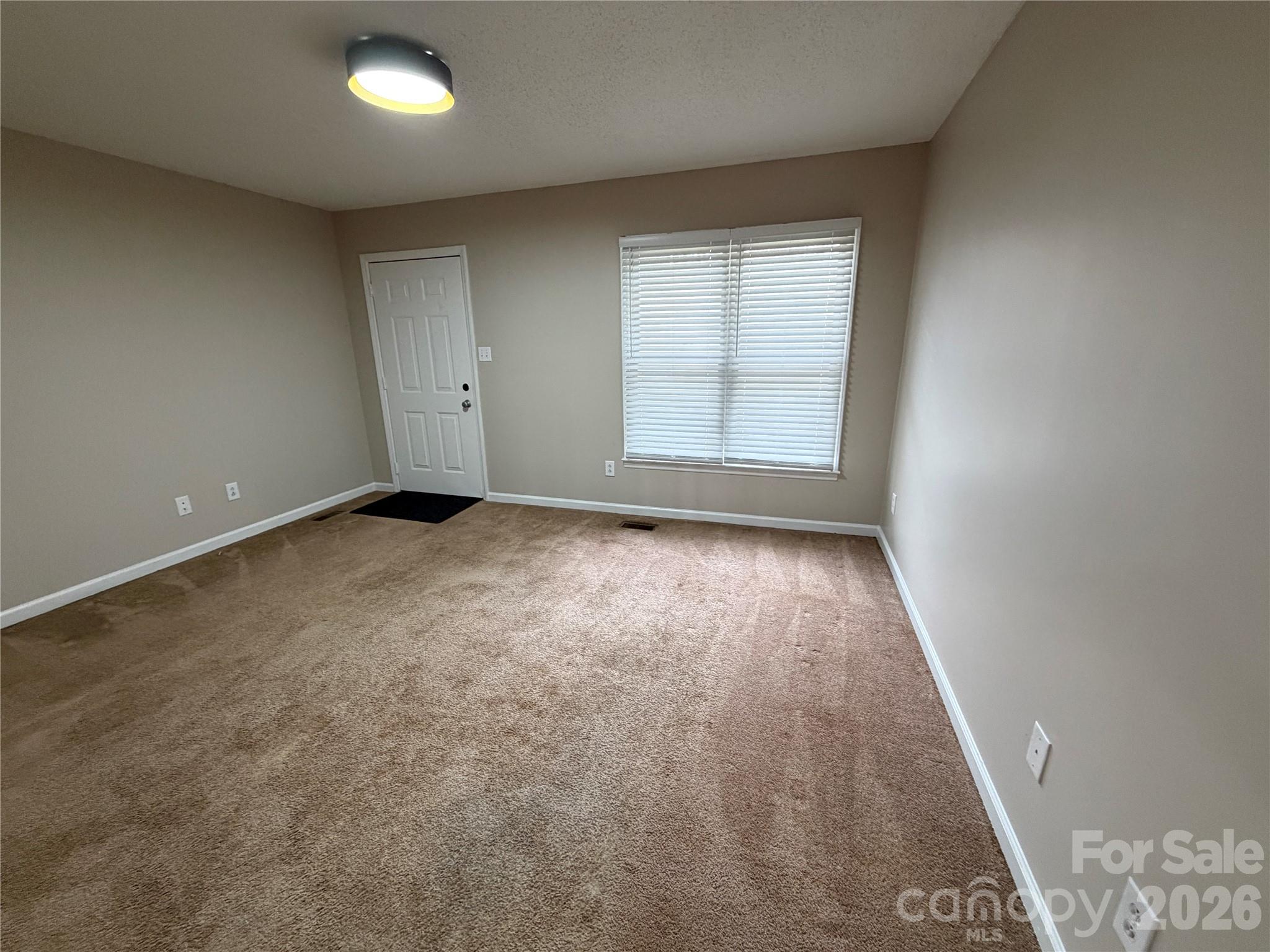 4051 Plum Street Conover, NC 28613 - Photo 2 of 10 an empty room with wooden floor and windows