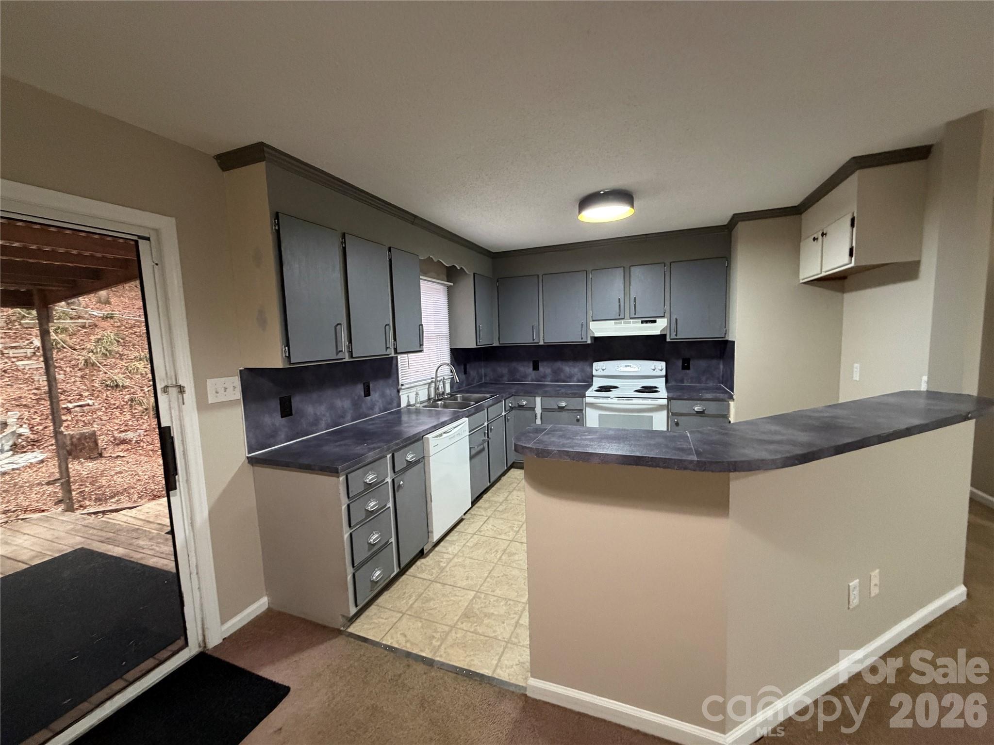 4051 Plum Street Conover, NC 28613 - Photo 3 of 10 a kitchen with stainless steel appliances granite countertop a stove a sink and a microwave