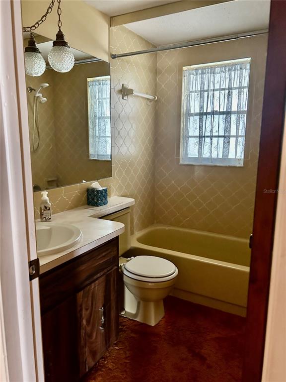 8511 Longboat Lane Hudson, FL 34667 - Photo 11 of 17 a bathroom with a sink a toilet and shower