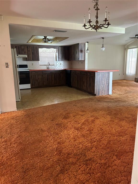 8511 Longboat Lane Hudson, FL 34667 - Photo 6 of 17 a room with kitchen island stainless steel appliances a sink cabinets and window