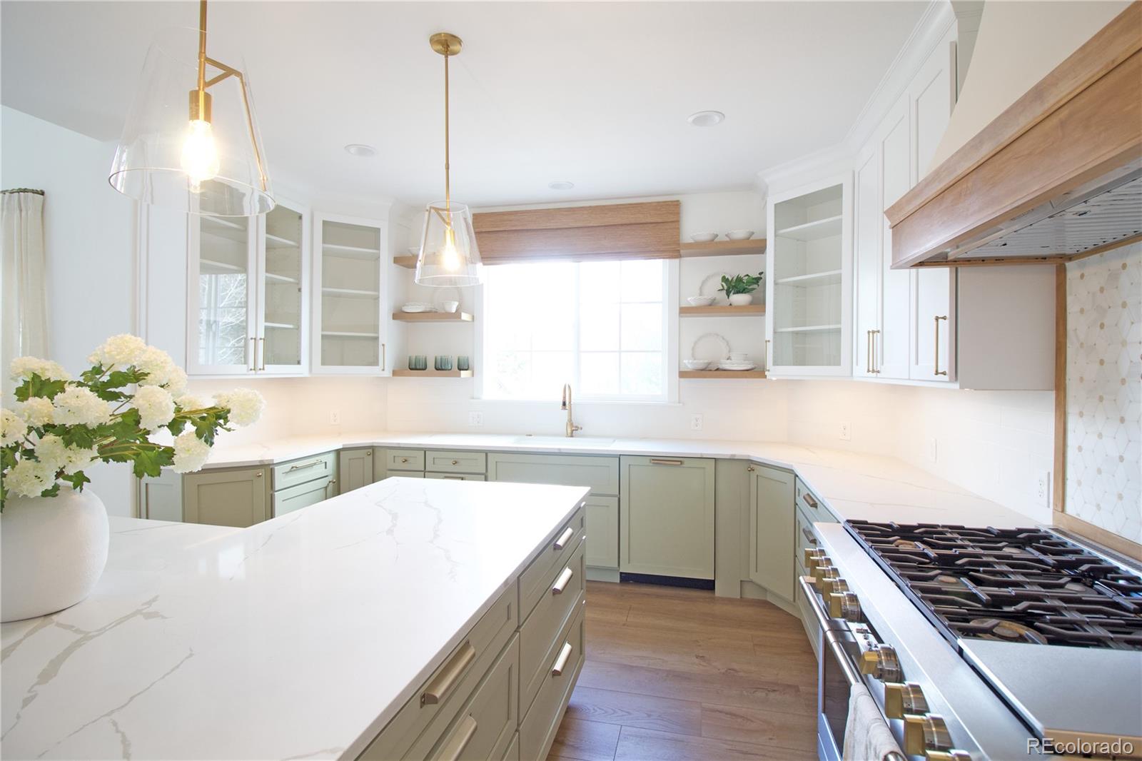 369 Shoreham Circle Castle Pines, CO 80108 - Photo 11 of 41 a kitchen with a sink stove and window