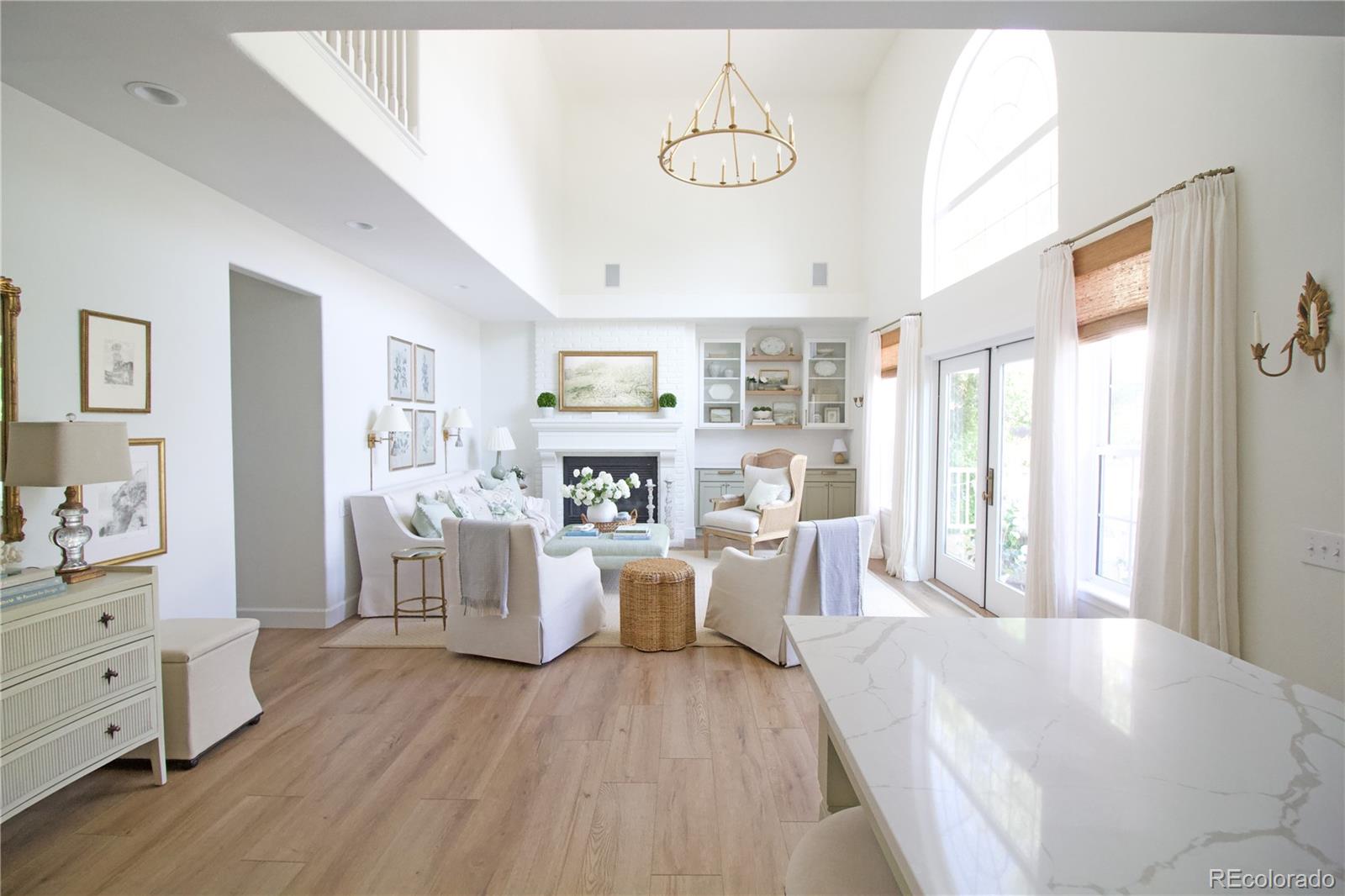 369 Shoreham Circle Castle Pines, CO 80108 - Photo 13 of 41 a living room with furniture and a wooden floor