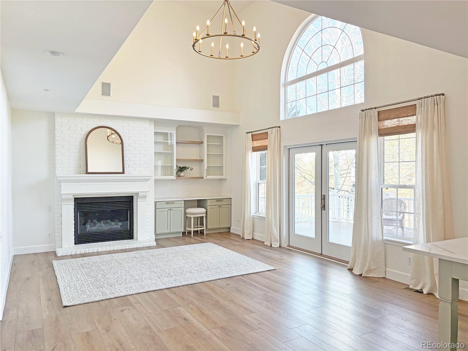 369 Shoreham Circle Castle Pines, CO 80108 - Photo 17 of 41 an empty room with wooden floor fireplace and windows