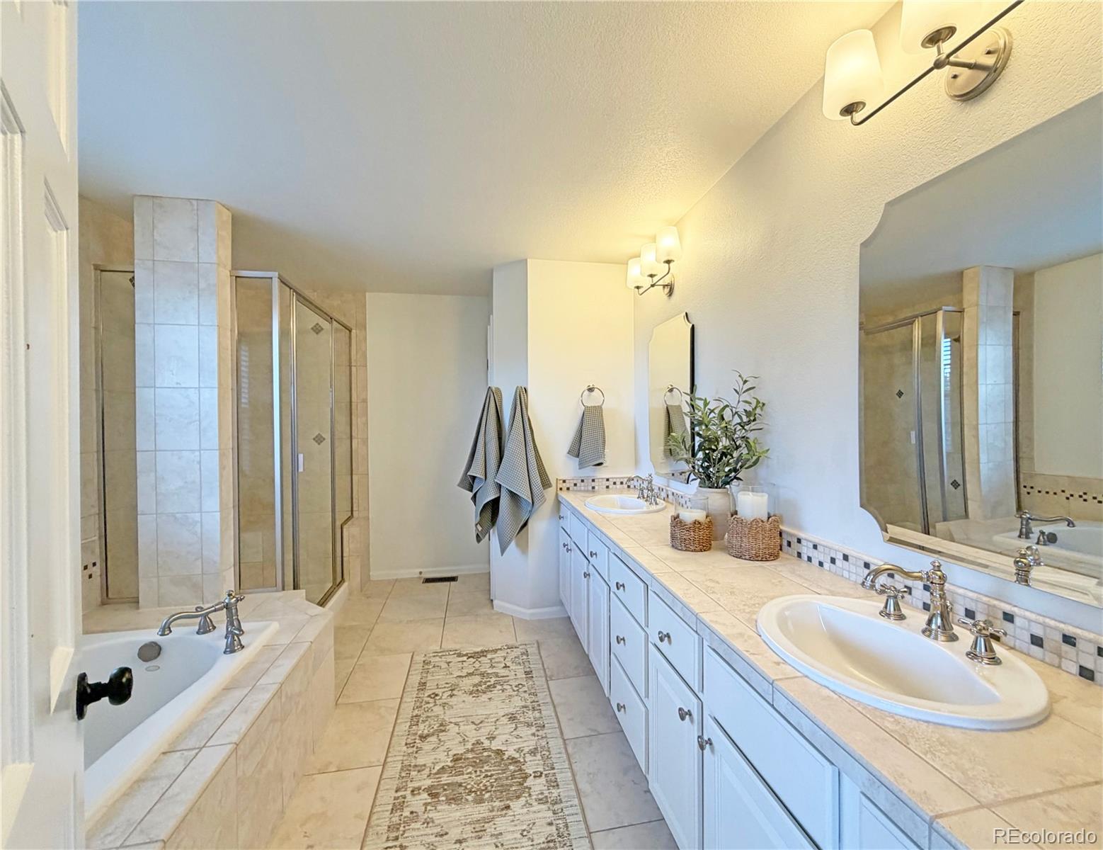 369 Shoreham Circle Castle Pines, CO 80108 - Photo 22 of 41 a bathroom with a double vanity sink and a mirror