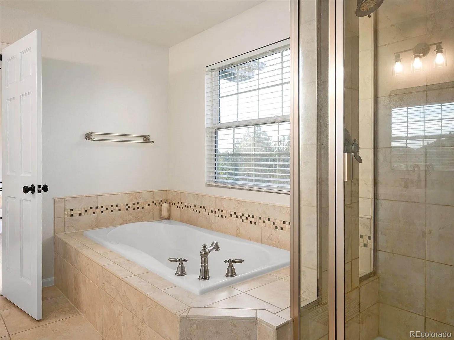 369 Shoreham Circle Castle Pines, CO 80108 - Photo 23 of 41 a white bath tub sitting next to a window
