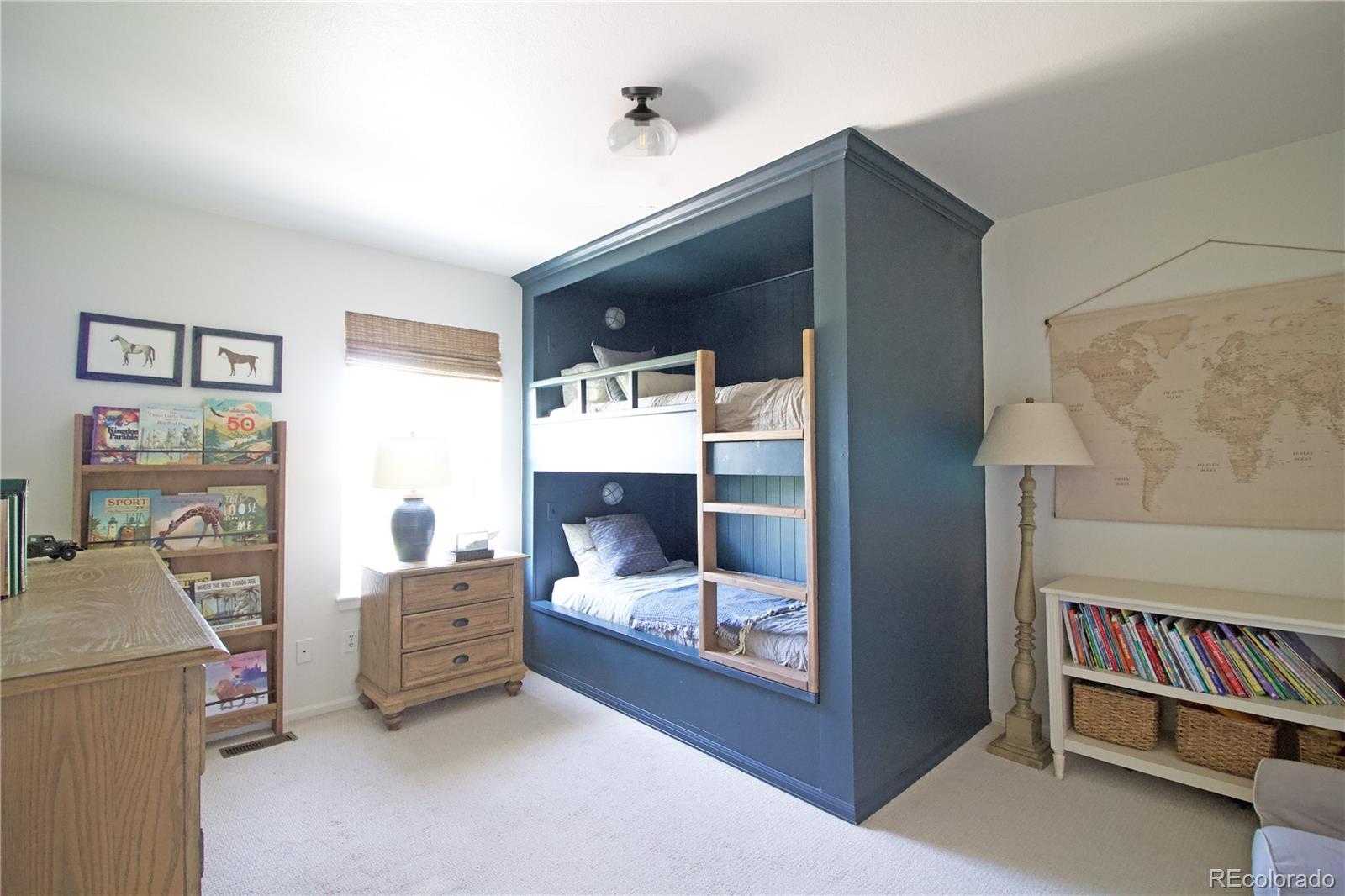 369 Shoreham Circle Castle Pines, CO 80108 - Photo 26 of 41 a living room with furniture and a baby crib