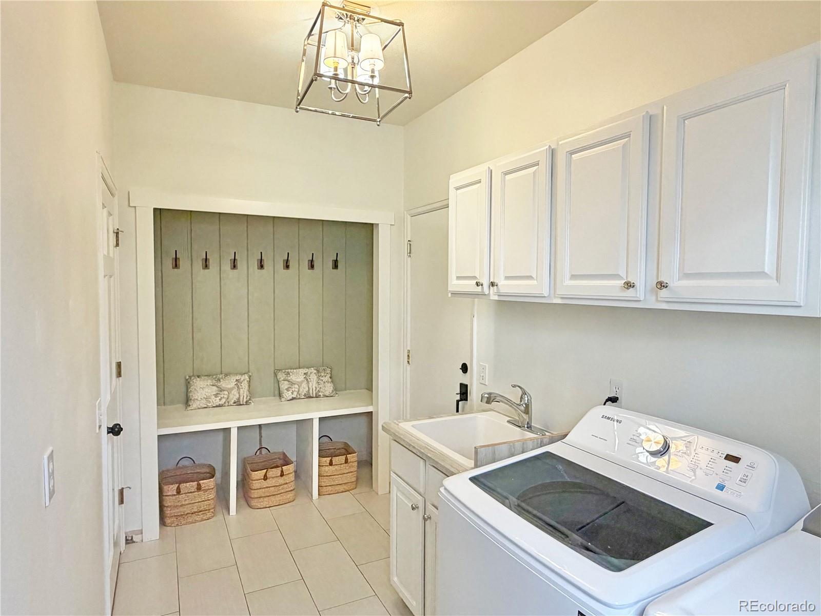 369 Shoreham Circle Castle Pines, CO 80108 - Photo 28 of 41 a utility room with washer and dryer