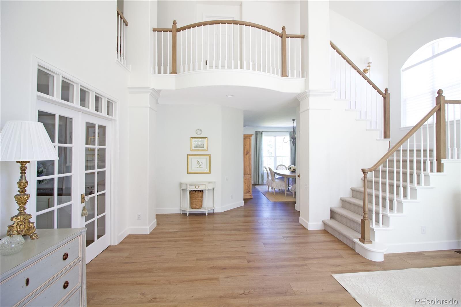 369 Shoreham Circle Castle Pines, CO 80108 - Photo 3 of 41 a view of an entryway with wooden floor