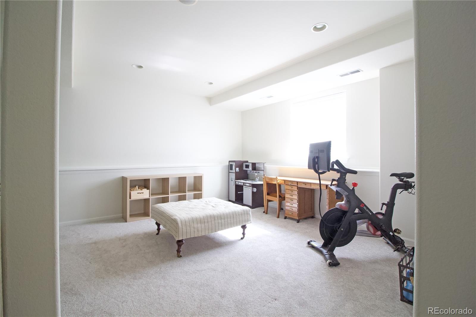 369 Shoreham Circle Castle Pines, CO 80108 - Photo 31 of 41 a view of a livingroom with furniture and windows