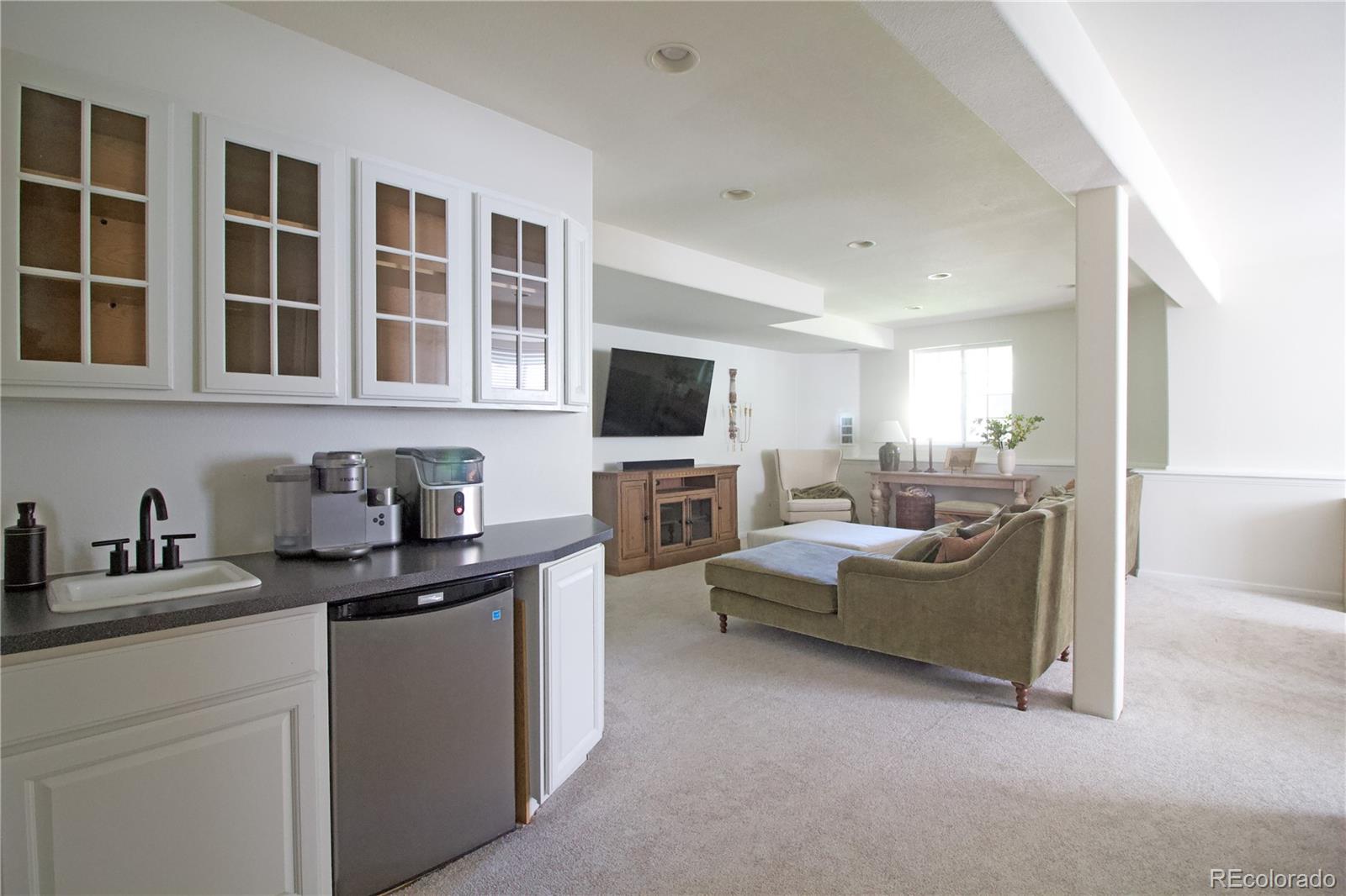 369 Shoreham Circle Castle Pines, CO 80108 - Photo 32 of 41 a kitchen with a sink and a stove top oven