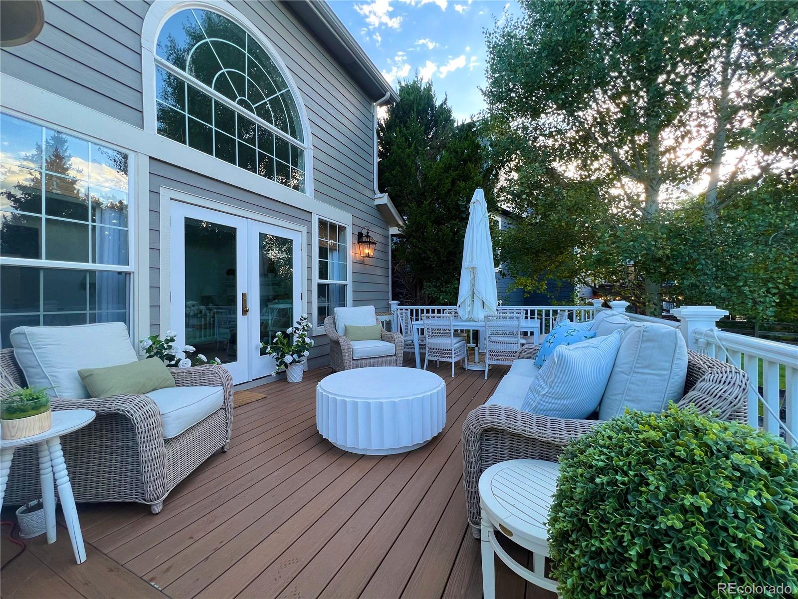 369 Shoreham Circle Castle Pines, CO 80108 - Photo 35 of 41 a view of a patio with couches table and chairs and potted plants