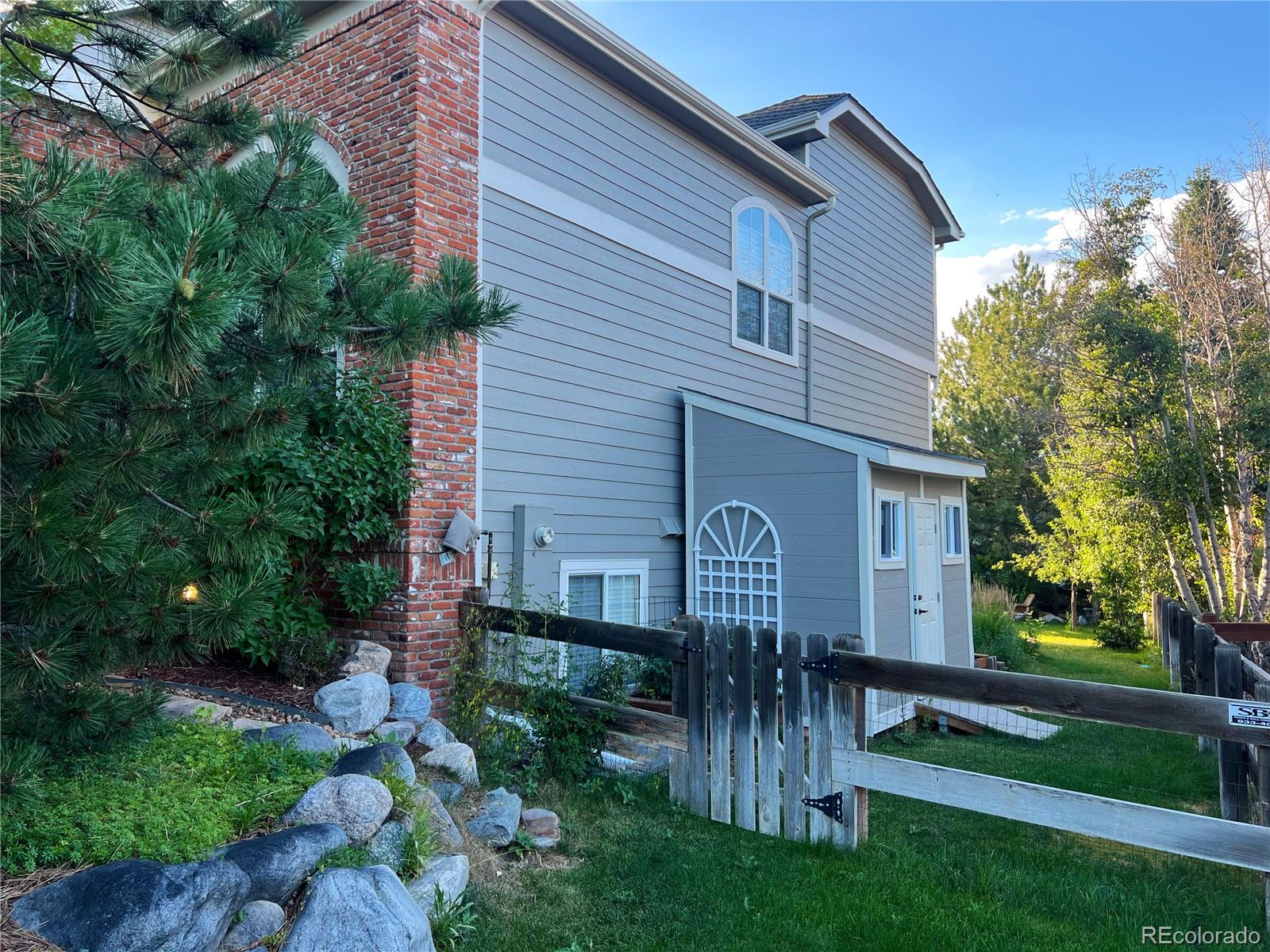 369 Shoreham Circle Castle Pines, CO 80108 - Photo 38 of 41 a front view of a house with a garden
