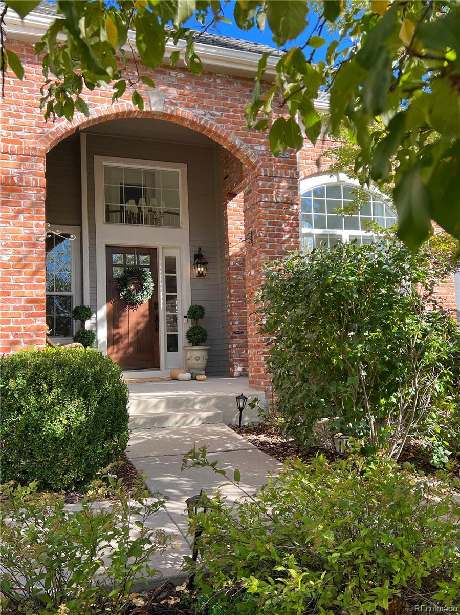 369 Shoreham Circle Castle Pines, CO 80108 - Photo 40 of 41 a view of a brick house with a large windows