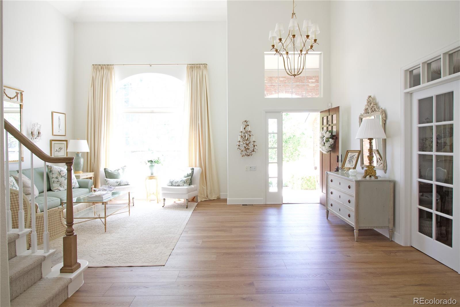 369 Shoreham Circle Castle Pines, CO 80108 - Photo 4 of 41 a living room with furniture or wooden floor and a large window