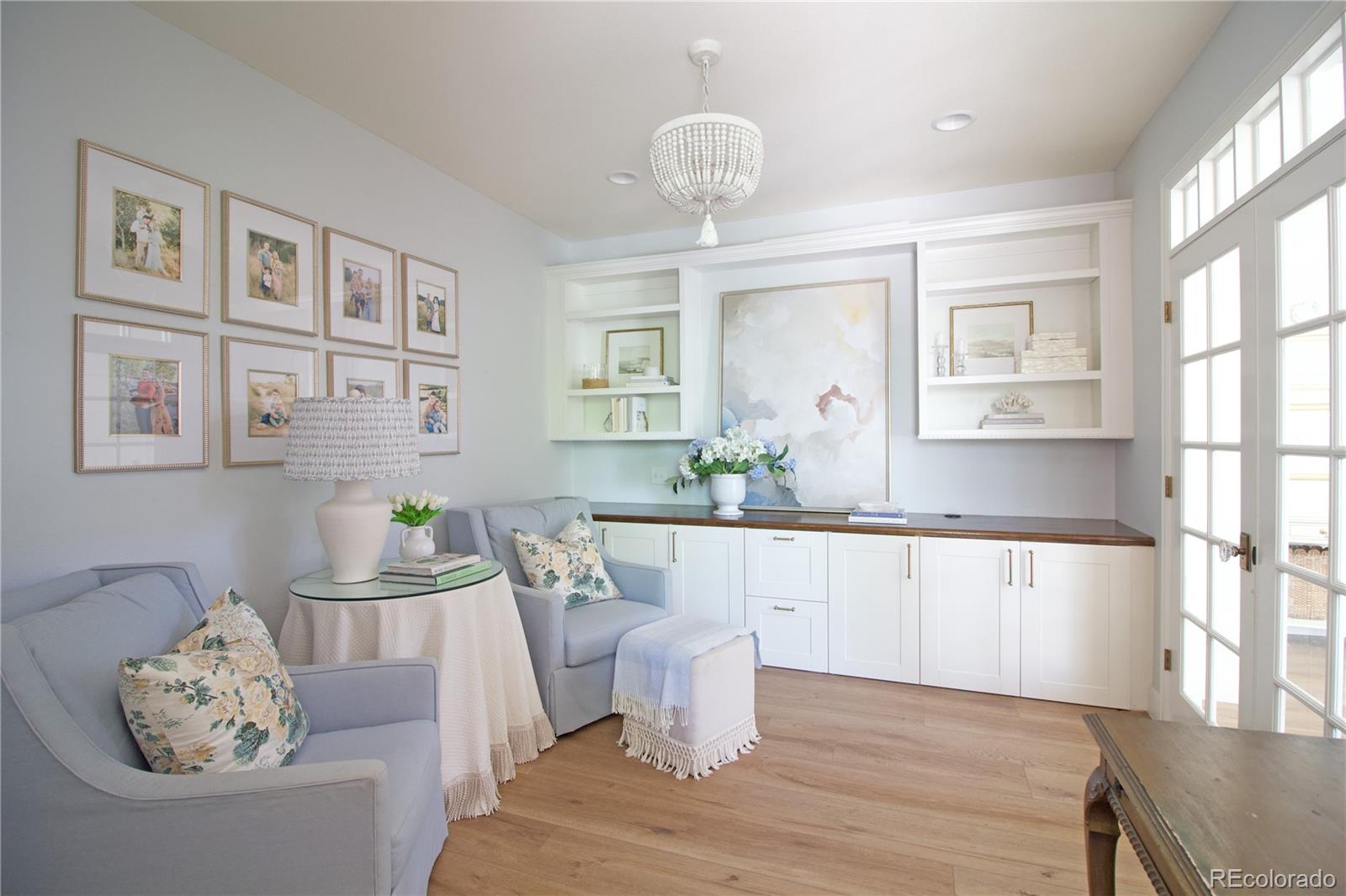 369 Shoreham Circle Castle Pines, CO 80108 - Photo 6 of 41 a large living room with stainless steel appliances kitchen view and wooden floor