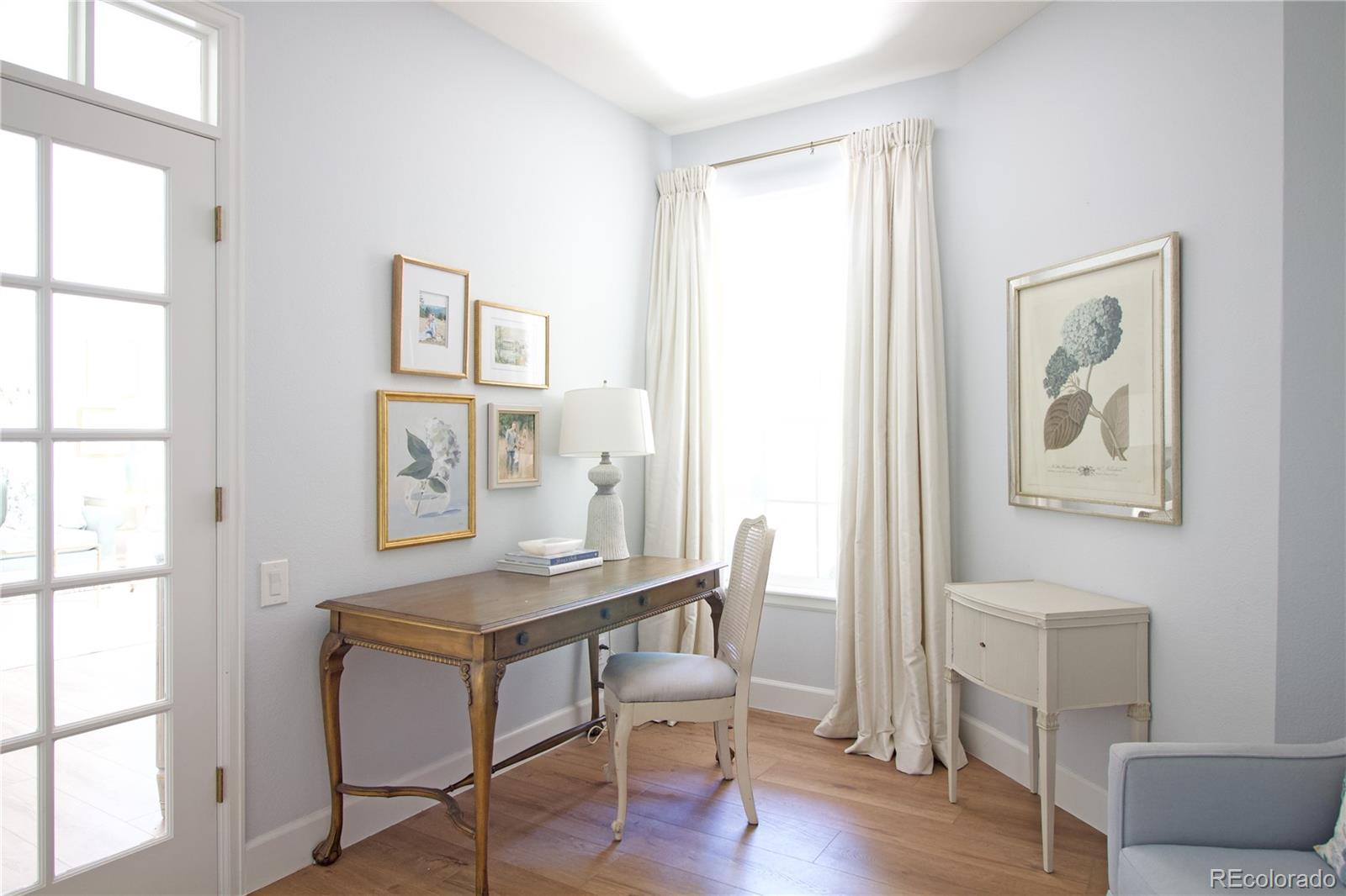 369 Shoreham Circle Castle Pines, CO 80108 - Photo 7 of 41 a view of a livingroom with furniture and wooden floor