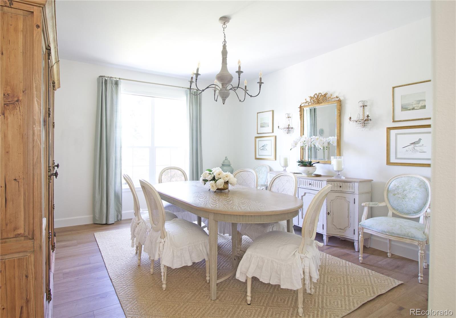 369 Shoreham Circle Castle Pines, CO 80108 - Photo 8 of 41 a view of a dining room with furniture and wooden floor