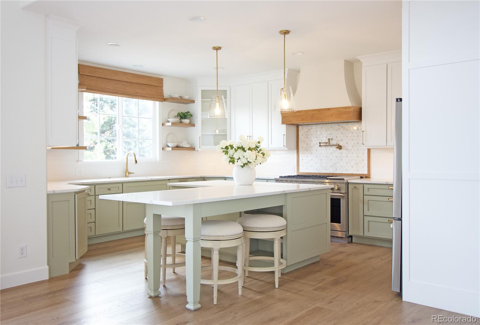 369 Shoreham Circle Castle Pines, CO 80108 - Photo 9 of 41 a kitchen with a sink and chairs