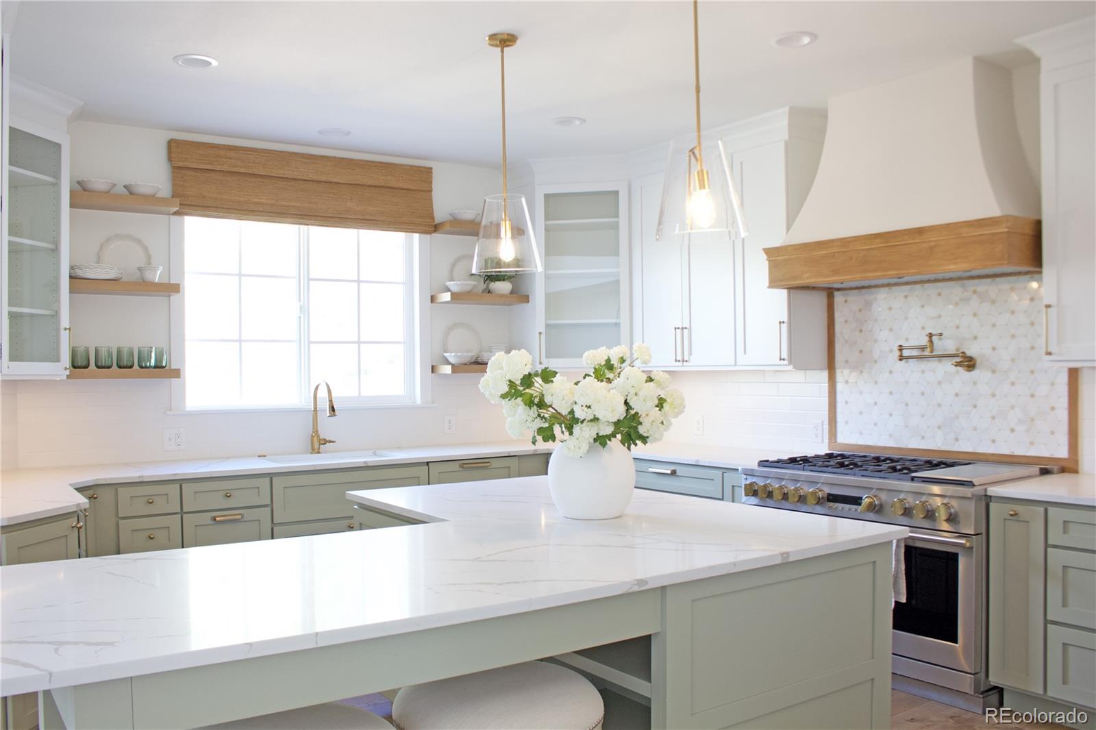 369 Shoreham Circle Castle Pines, CO 80108 - Photo 10 of 41 a kitchen with stainless steel appliances granite countertop a sink a stove and a wooden floors