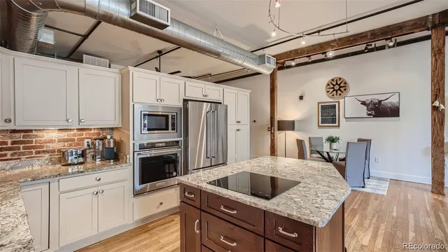 a view of living room with furniture and a fireplace