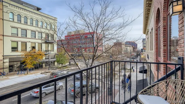 a living room with furniture a fireplace and a chandelier