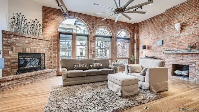 a hallway with front door wooden floor and windows