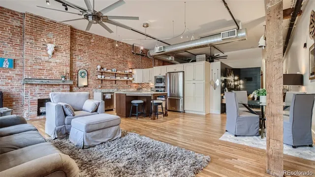 a view of a kitchen with refrigerator and chairs