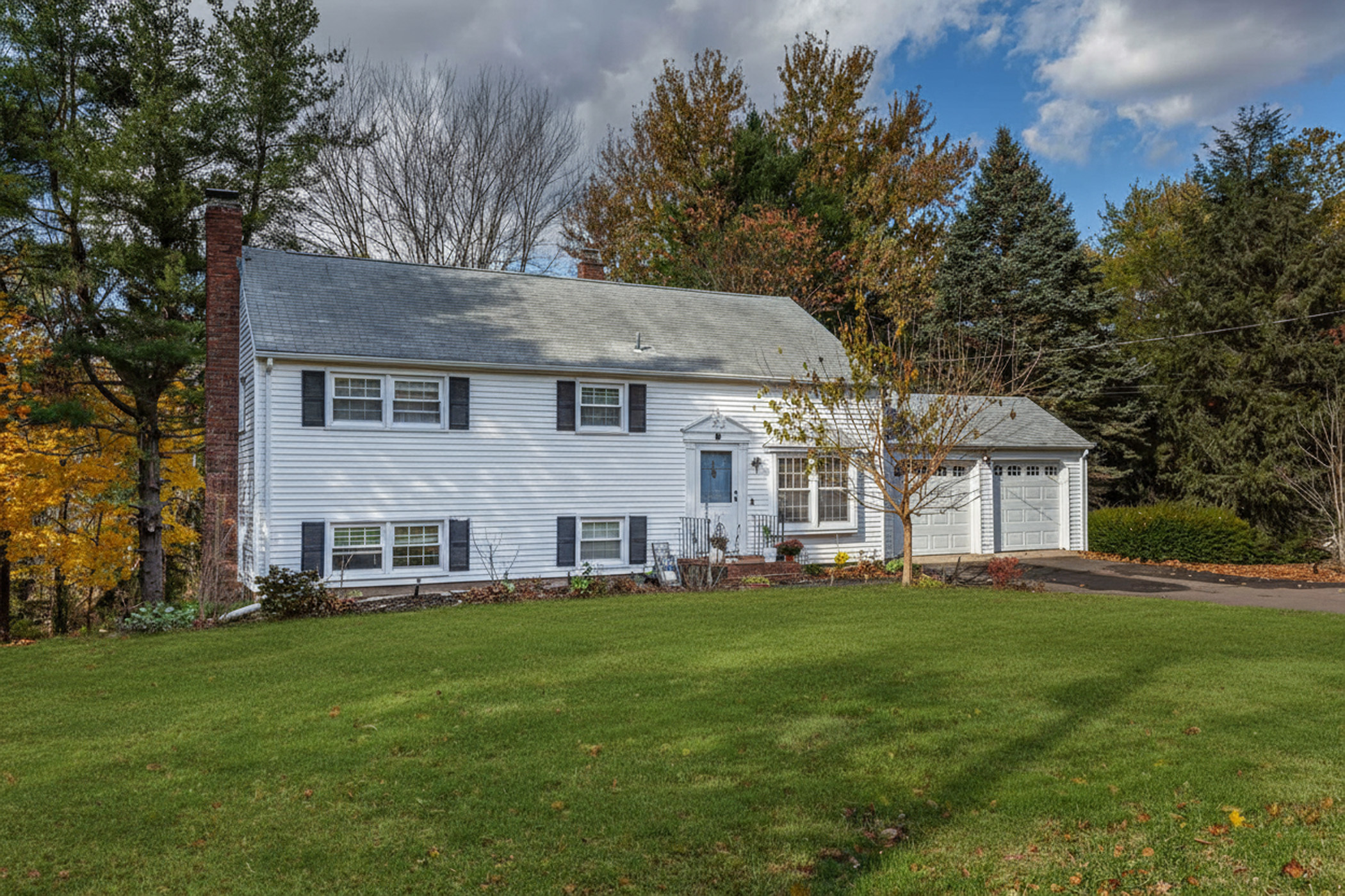 a front view of house with yard and green space