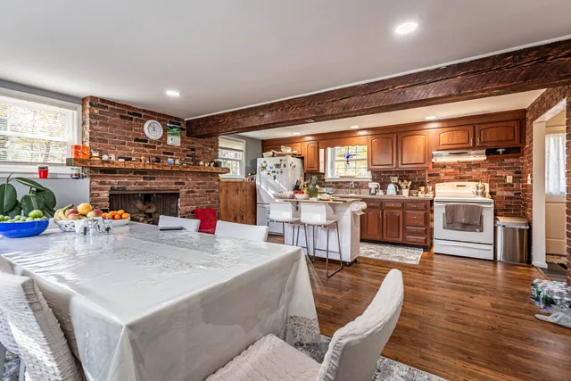 a living room with furniture and a kitchen view