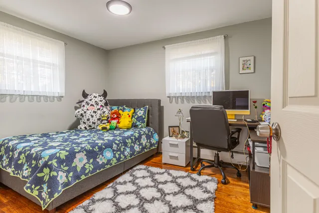 a bed room with a bed and a chair