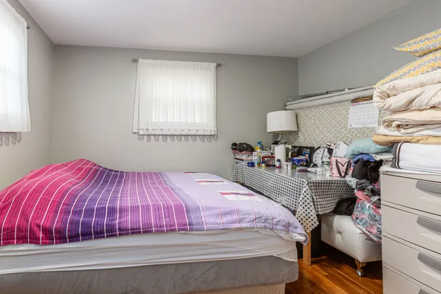 a bedroom with bed and window