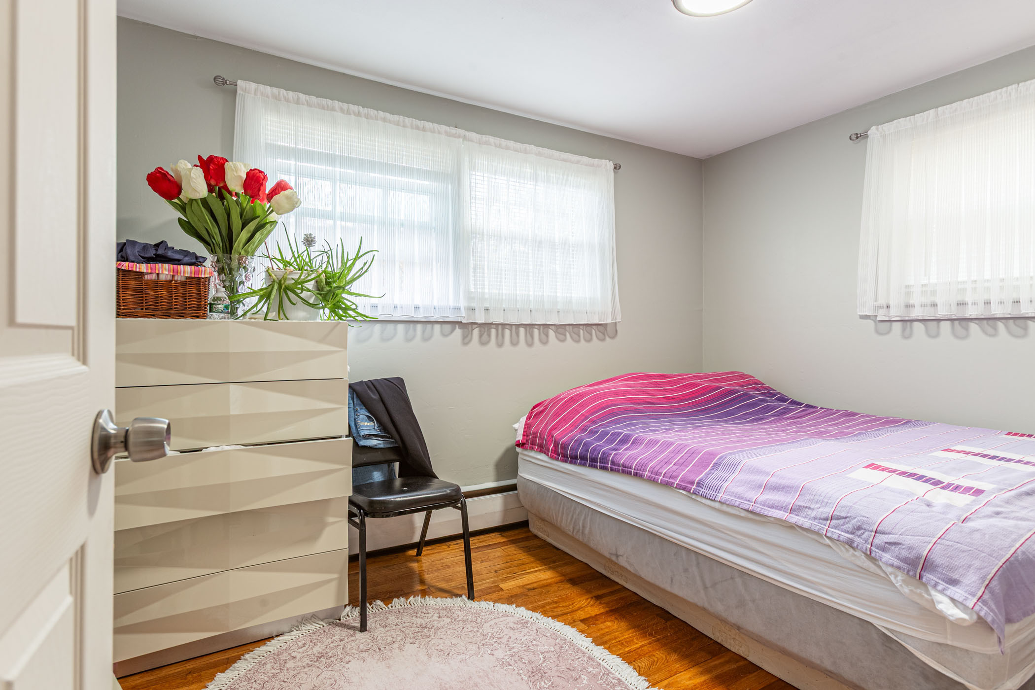 91 Goebel Road Hamden, CT 06514 - Photo 28 of 39 a bedroom with a bed table chair and a potted plant