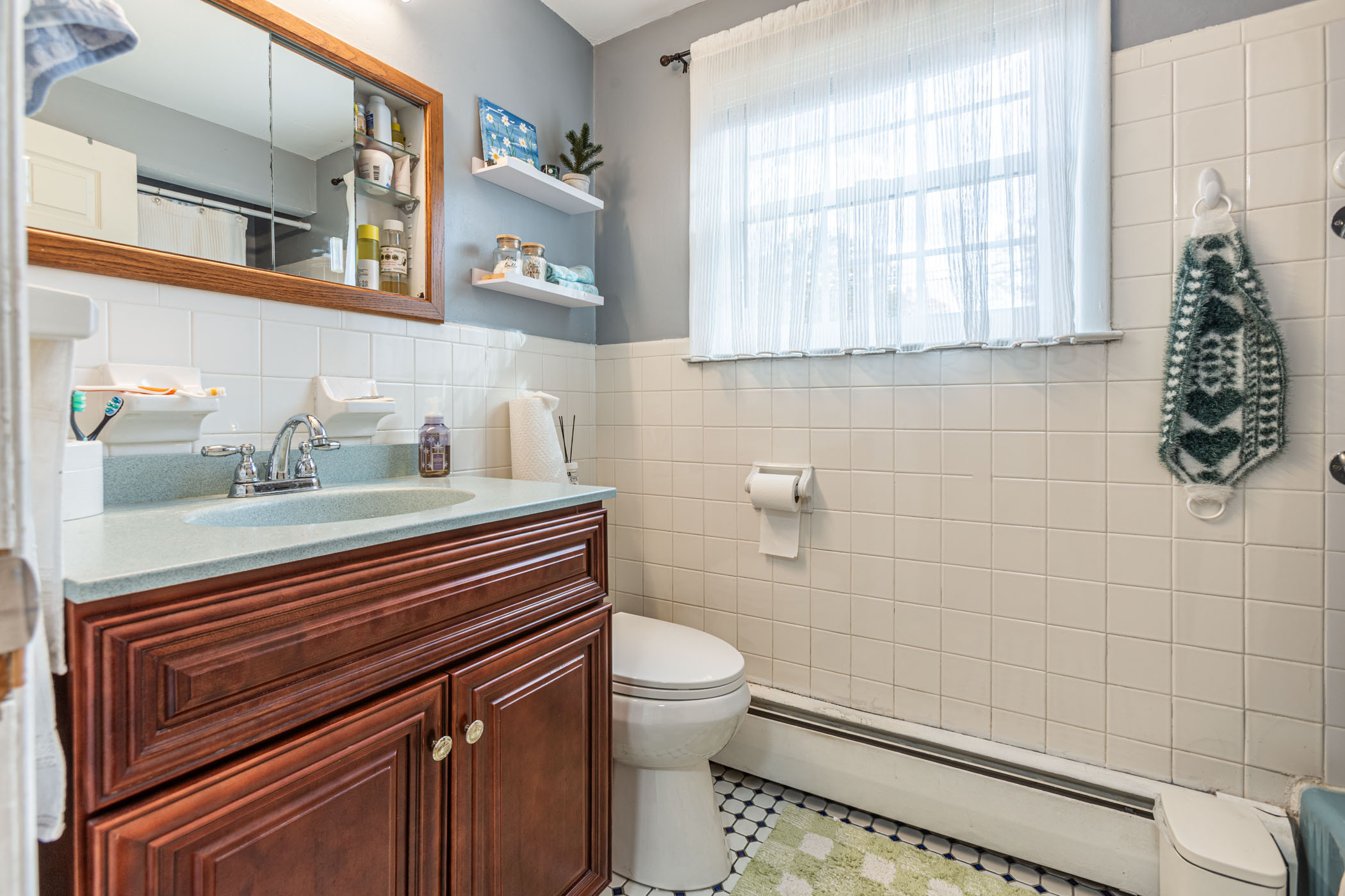 91 Goebel Road Hamden, CT 06514 - Photo 29 of 39 a bathroom with a sink a toilet and a window