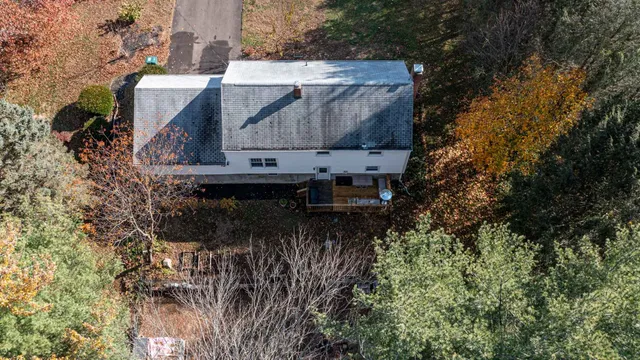 an aerial view of residential house with outdoor space and seating