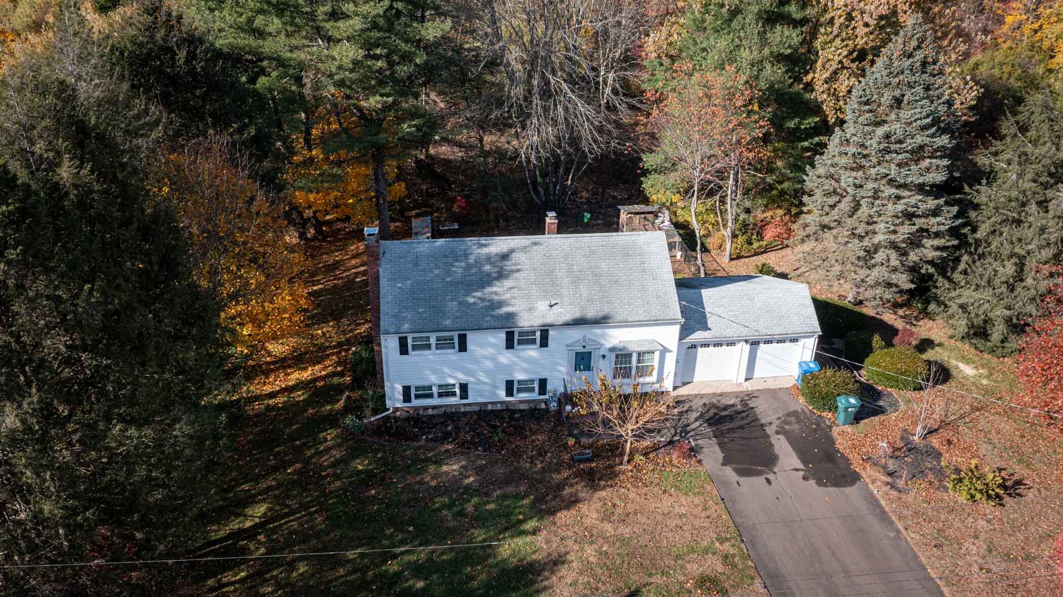 91 Goebel Road Hamden, CT 06514 - Photo 7 of 39 an aerial view of a house with yard and trees all around