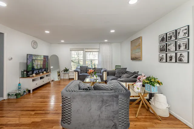 a living room with fireplace furniture and a flat screen tv